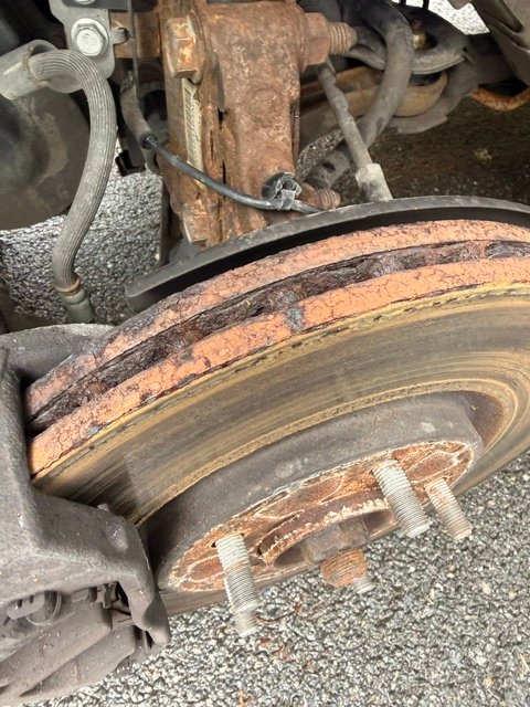 Brake rotor edge showing deep wear grooves